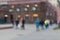 Blurred abstract background. Unrecognizable silhouettes of people walking on city street