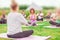 Blurred - Abstract, defocused photo, for background. Yoga, meditation sitting group outdoors