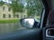 Blurred abstract image of city street through the automobile glass with raindrops. Rainy sad overcast weather. Cityscape through v