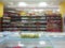 Blurred abstract image. Goods on the shelf of a grocery store. Various ketchup, sauces and seasonings