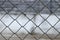 Blurred abstract landscape grid fence. Metal grid texture background.