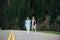 Blurred abstract photo of a couple of hipsters embracing on a mountain road in the woods and. Holidays in the mountains. Vertical