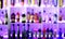 Blurred abstract vibrant bar shelves with alcoholic drinks in the club