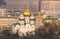 Blurred abstract view of orthodox church with golden cupola inside the Moscow city under spring sun light