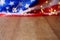 Blurred American flag and garland on wooden table