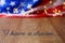 Blurred American flag and garland on wooden table.