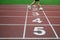 Blurred athlete by a slow camera shutter speed crossing the finish line after sprint track