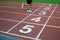 Blurred athlete by a slow camera shutter speed crossing the finish line after sprint track