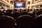 Blurred Audience in a theater, on a concert. Viewers watching the show