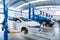 Blurred of of Auomobile repair, Car service centre auto repair with wehicle raised on lift workshop. Car repair service center
