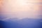 Blurred background of blue mountain and pink sky