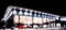 Blurred background with car dealership exterior. Abstract blurred photo of modern building motor showroom. Blur car show room