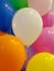 Blurred background of colorful bright balloons, festive group of balloons
