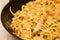 blurred background homemade noodles with chicken meat in a fryin