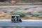 A blurred background image of three wheeler autorikshaw speeding on a motorway.