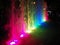 Blurred background of light fountain with round light bokeh at night.Beautiful multicolored dancing fountains at night
