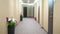 Blurred background. long hallway corridor with flowers in vases