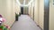Blurred background. long hallway corridor with flowers in vases