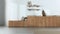 Blurred background, minimalist japandi kitchen. Wallpaper, wooden cabinets, shelves and bench. Concrete floor, wabi sabi interior