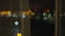 Blurred background of night window with city lights with curtain