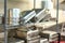 Blurred background of restaurant : Stack of stainless steel tray on the shelf.