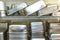 Blurred background of restaurant : Stack of stainless steel tray on the shelf.