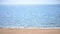 Blurred background. Sea with white sun reflections, yellow sandy beach