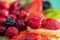 Blurred background of strawberries, kiwi, currants, raspberry, pineapple, blackberry. Delicious dessert. Soft focus. Closeup