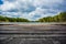 Blurred background with wooden pier on the shore of a large lake in the forest. Wonderful spring landscape. A cozy place for rest,