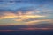blurred beautiful multi-colored sky with clouds at sunset or sunrise. The sun`s rays color the clouds.