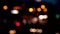 Blurred bokeh of cars in traffic on the road at night. Abstract bright blurred colored bokeh.