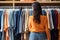 Blurred bokeh effect woman browsing clothing rack with blurred bokeh background in department store