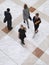 Blurred Business People Walking On Tiled Floor