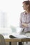 Blurred Businesswoman With Focus On Documents On Desk