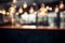 Blurred cafe scene with an artistic background of hanging light bulbs