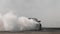 Blurred car drifting diffusion race drift car with lots of smoke from burning tires on speed track, Professional driver drifting