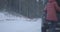 Blurred Caucasian woman opening car hood, taking road safety vest and approaching to camera. Unrecognizable female