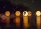 Blurred city lights with rain drops foreground. Unfocused colorful lights behind glass with drops. Shiny lights of night bokeh.