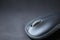 blurred computer mouse on a gray background, bokeh