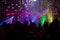 Blurred concept night scene in concert party with audience and colourful led lighting.