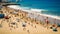 Blurred crowded day at the beach on sunny summer day and tilt shift effect