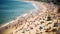 Blurred crowded day at the beach on sunny summer day and tilt shift effect