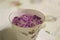 Blurred cup with lilac flowers on tablecloth retro colors