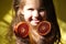 Blurred Cute happy little girl with orange fruit.  Light and shadow. Sunset. Shallow DOF