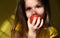 Blurred Cute little girl licking orange fruit.  Light and shadow. Sunset. Shallow DOF