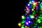 Blurred decoration of Christmas tree on dark background.