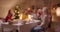 Blurred defocus Big Caucasian family sits down a Christmas table evening dinner union joy smile conversation home