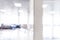 Blurred defocused bokeh background of exhibition hall or convention centre hallway. Business trade show modern white interior arch