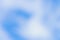 Blurred and defocused horizontal background of blue sky with white clouds. Soft focus backdrop or blank for copy space