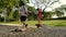 Blurred or defocused people walking in the park with children and dogs.